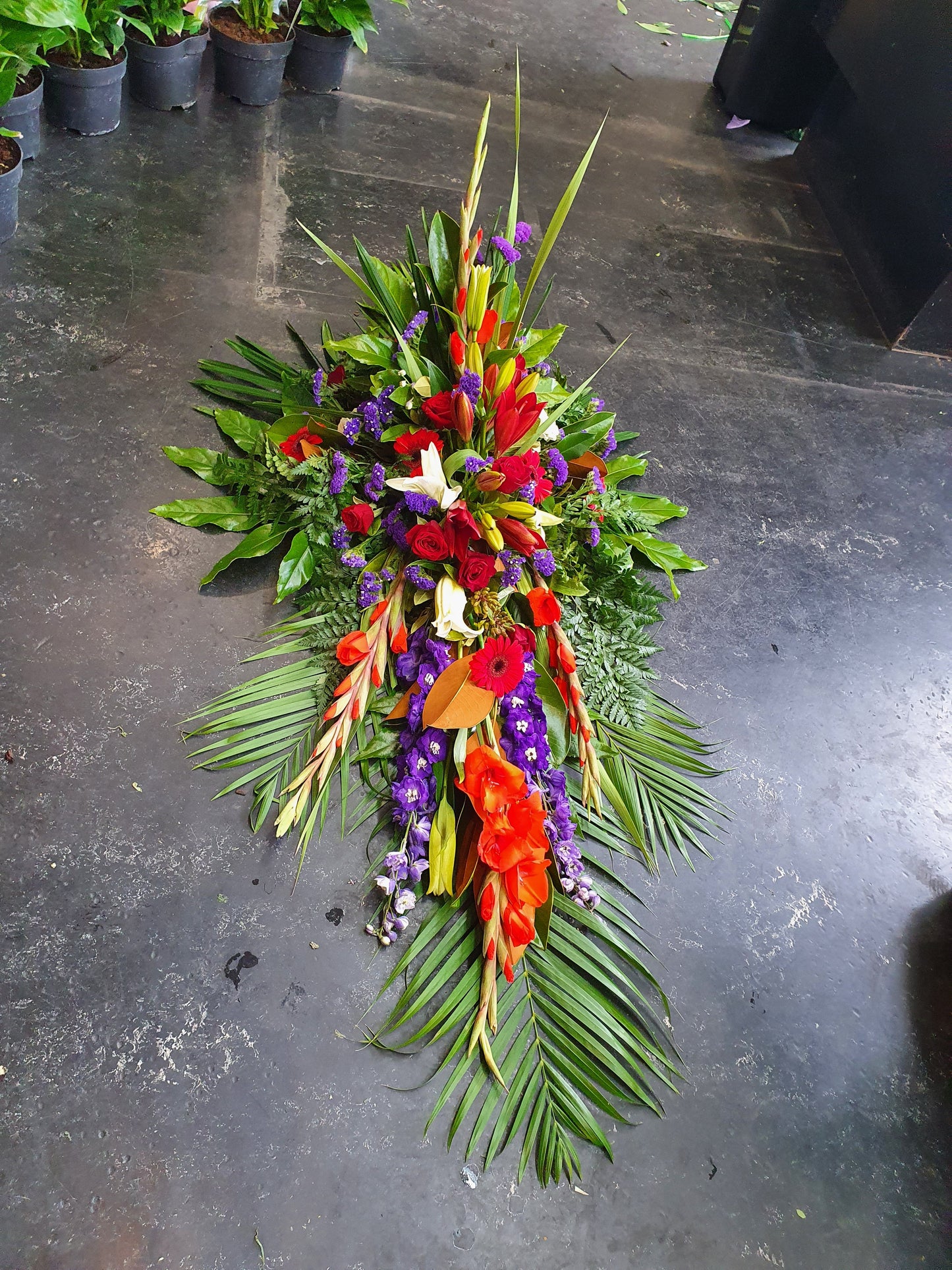 Gorgeous foliage and flowers help create texture and interset to these stunning traditional casket sprays